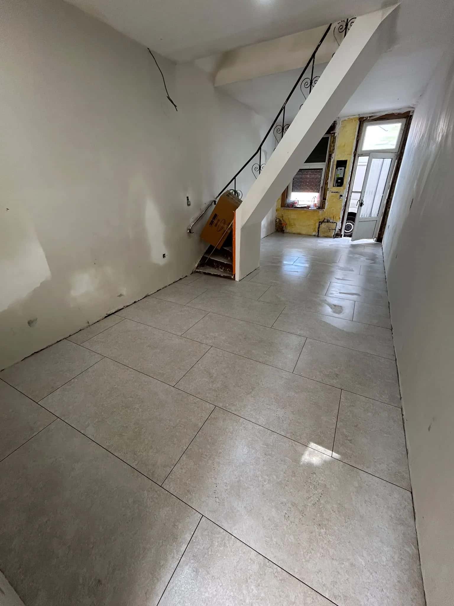 Sol grand format posé d'un seul tenant jusqu'à la porte d'entrée
